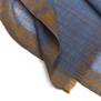 Close up of a blue and orange checked scarf.